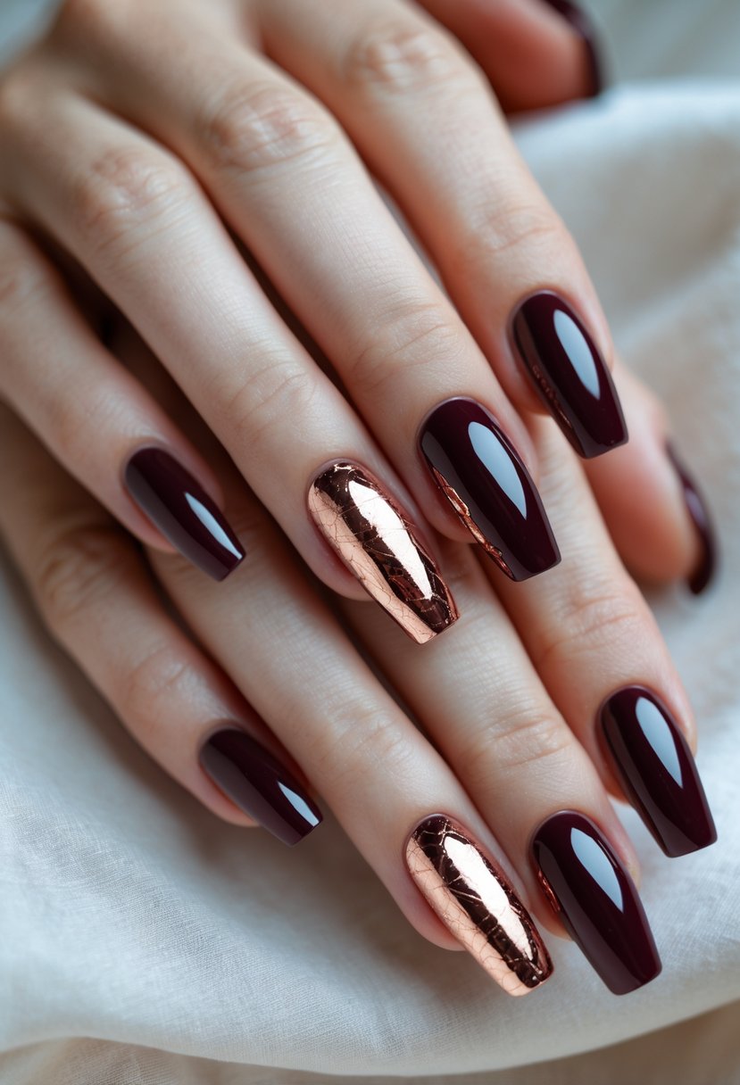 Close-up of hands with glossy burgundy nails decorated with rose gold foil designs.