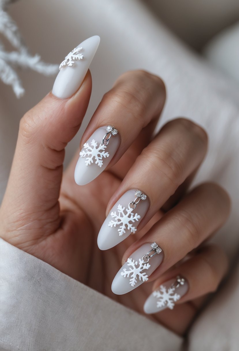 Close-up of a hand with frosted white acrylic nails decorated with silver and white snowflake charms.