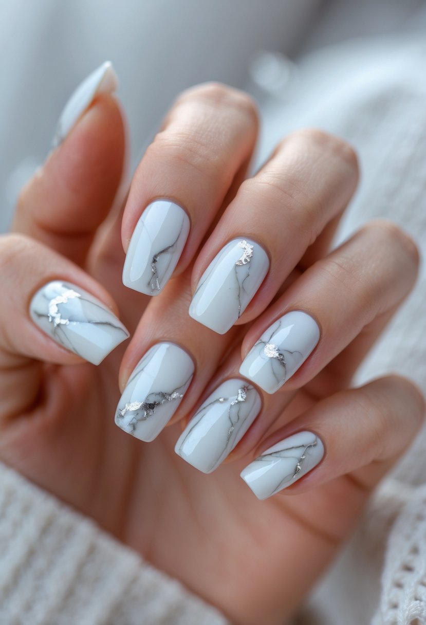 Close-up of a hand with 16 white and gray marble patterned nails on a light background.