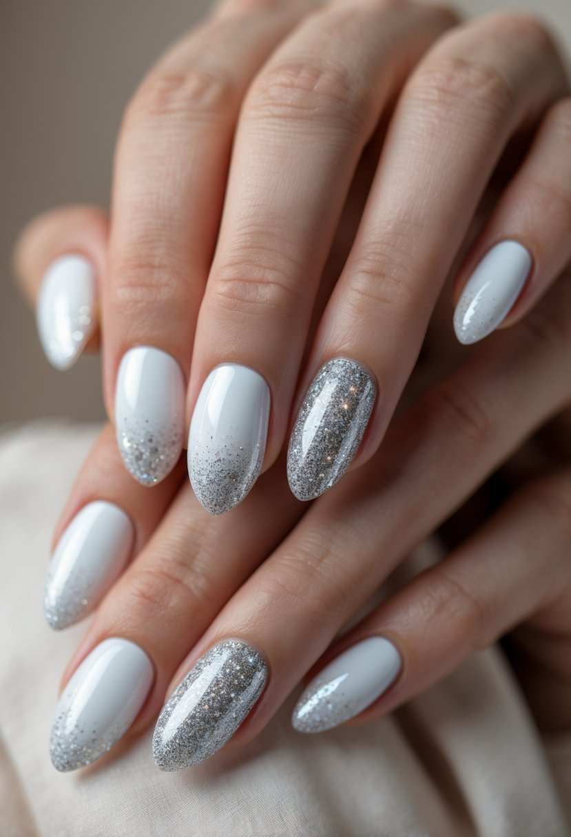 Close-up of hands with white nails fading into silver glitter on the tips.