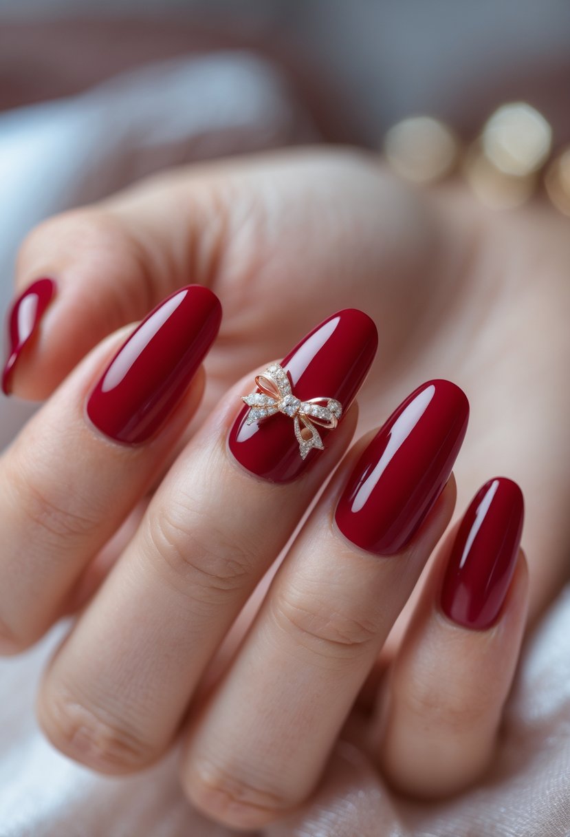 Close-up of a hand with cherry red nails featuring small bow accents on a few nails.