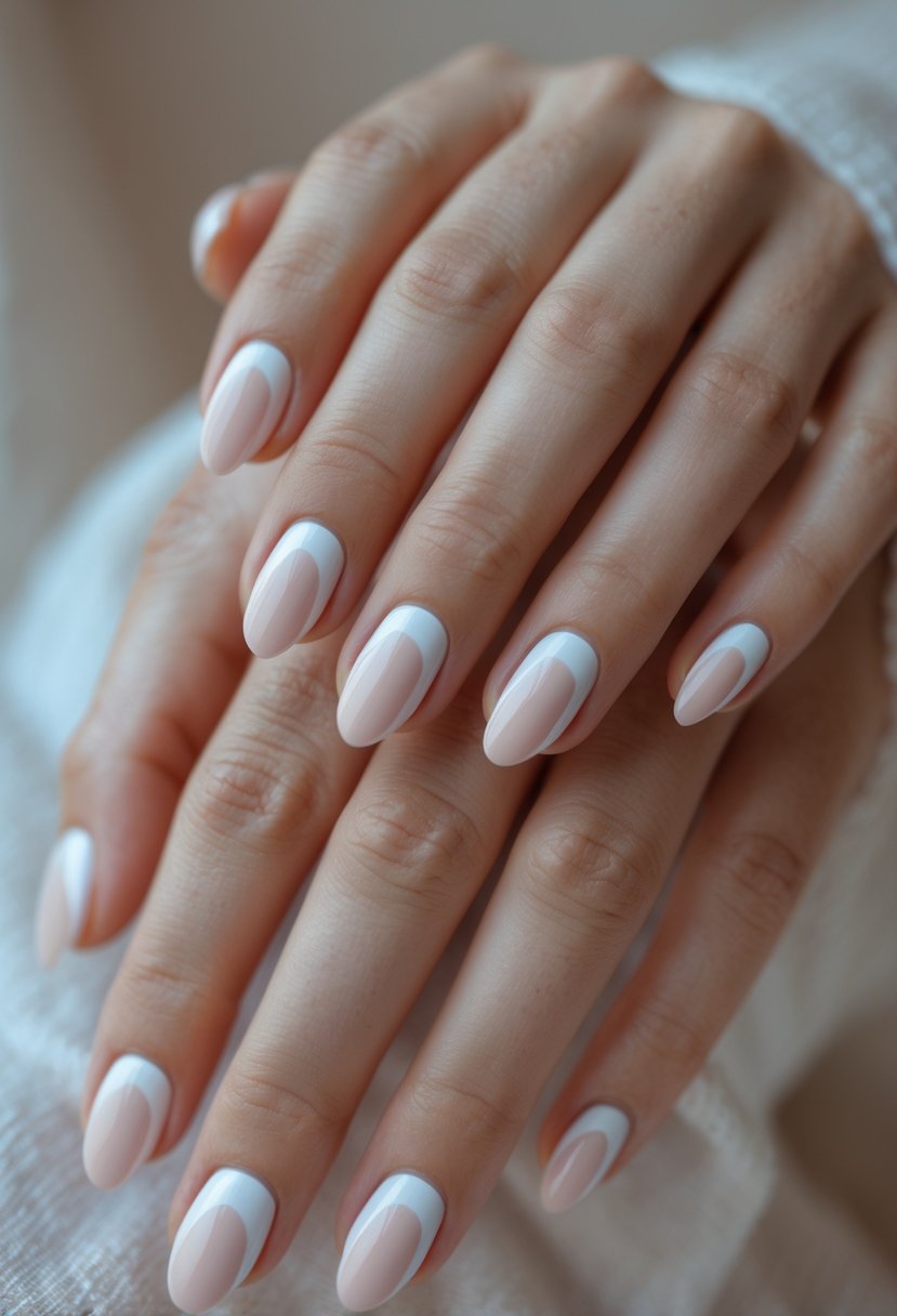 Close-up of hands showing 21 simple half moon nail designs with natural base color and pastel crescent shapes at the nail beds.