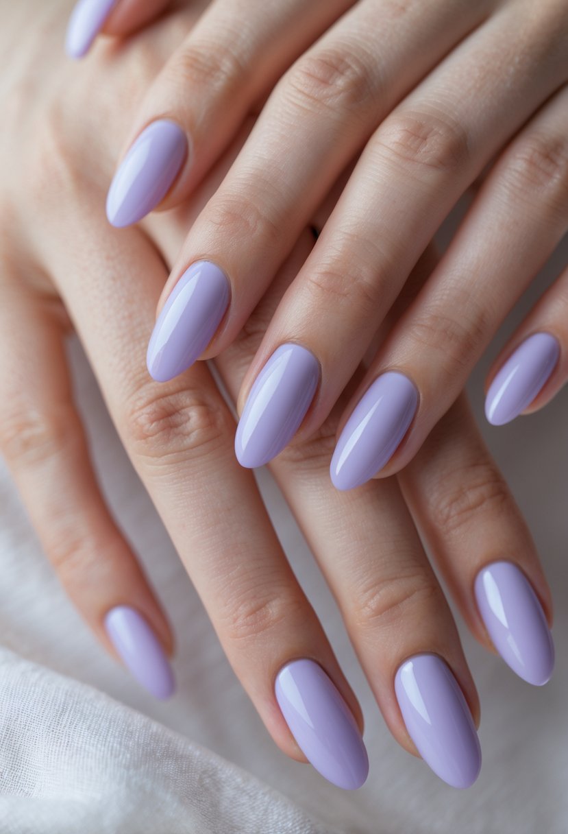 Close-up of hands with soft lavender-colored nails against a neutral background.