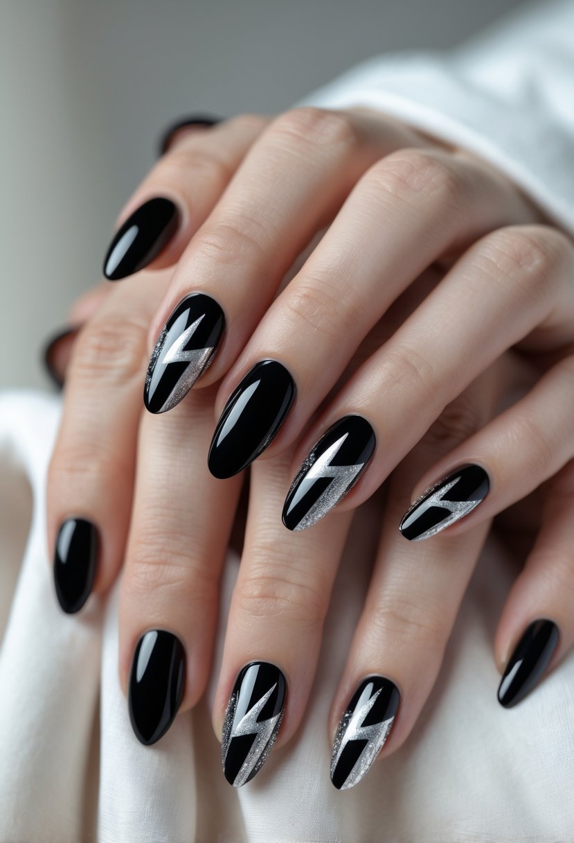 Close-up of hands with black nails decorated with silver lightning bolt designs.